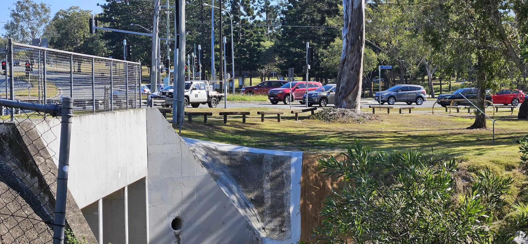 The eastern side of the bridge over Downfall Creek. The cars in the background are on Murphy Road, waiting for the lights at Gympie Road.